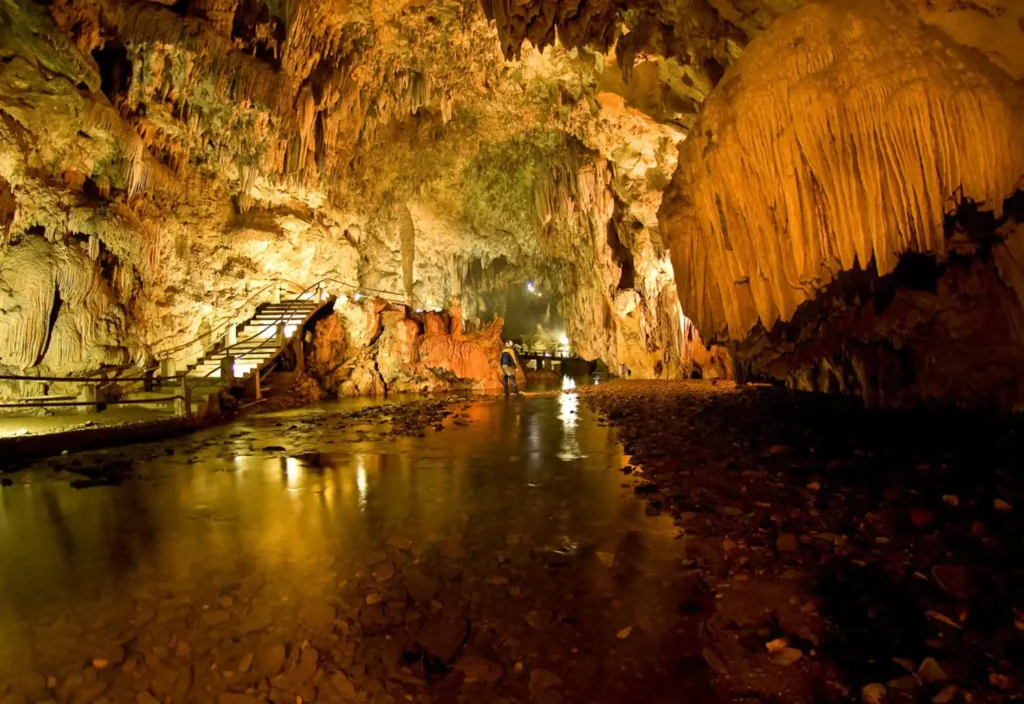 Golden light inside Devil's Cave (Caverna do Diabo) in Eldorado, São Paulo, a stunning stop for exploring the Ribeira Valley