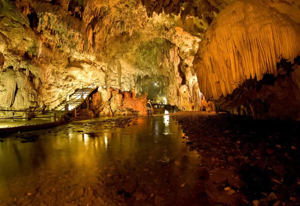 Golden light inside Devil's Cave (Caverna do Diabo) in Eldorado, São Paulo, a stunning stop for exploring the Ribeira Valley