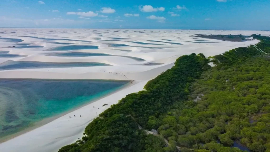 Breathtaking aerial landscape of Lençóis Maranhenses with endless white sand dunes and natural lagoons under a clear sky